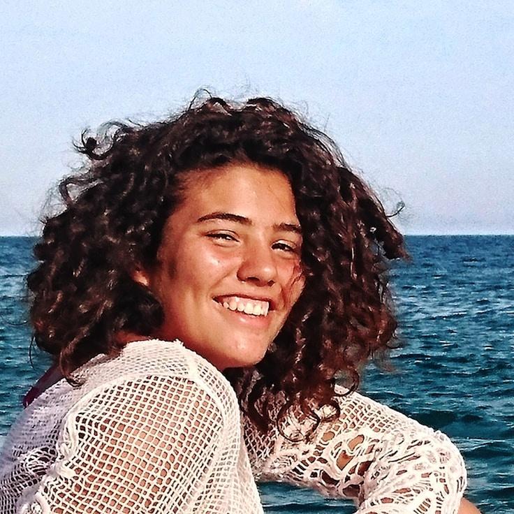 Avery Chen, Lead Design Curator at BridgeSproutMirror, reviewing corporate floral arrangements